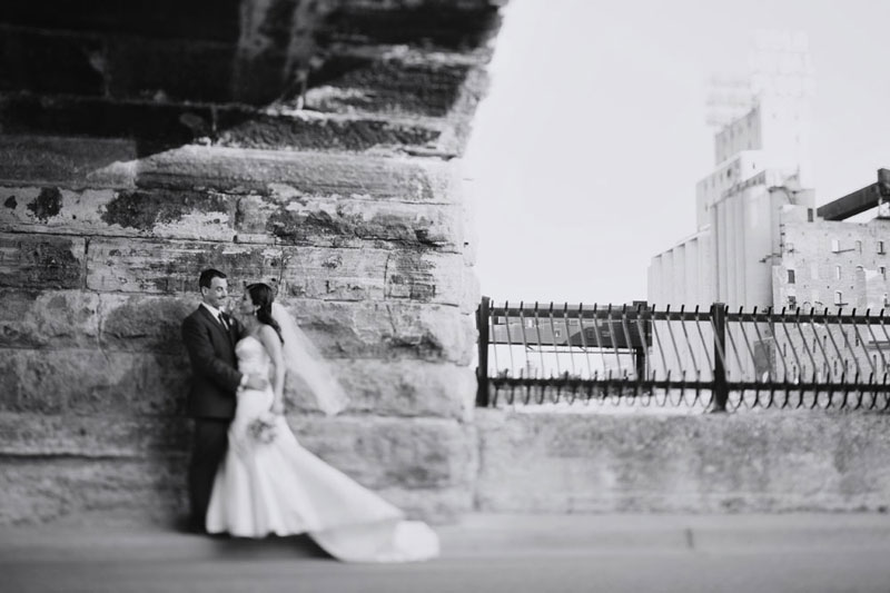 bride and groom at stone arch bridge