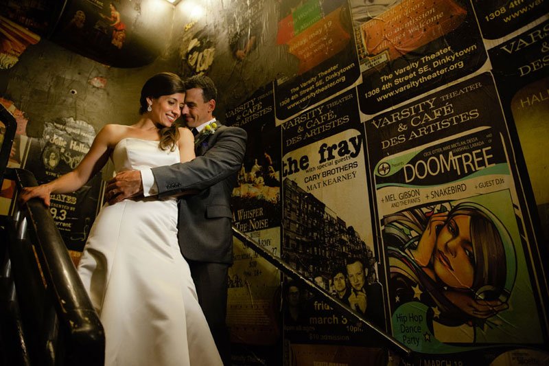bride and groom with music posters including doomtree at varsity theater wedding minneapolis