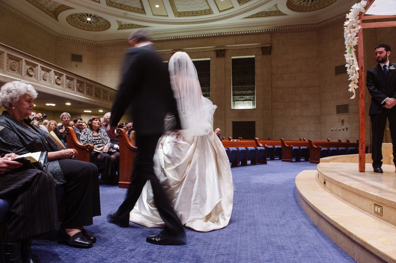 groom walks around bride during Temple Israel Wedding Minneapolis MN