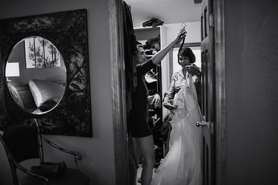 bride and mom get dress 