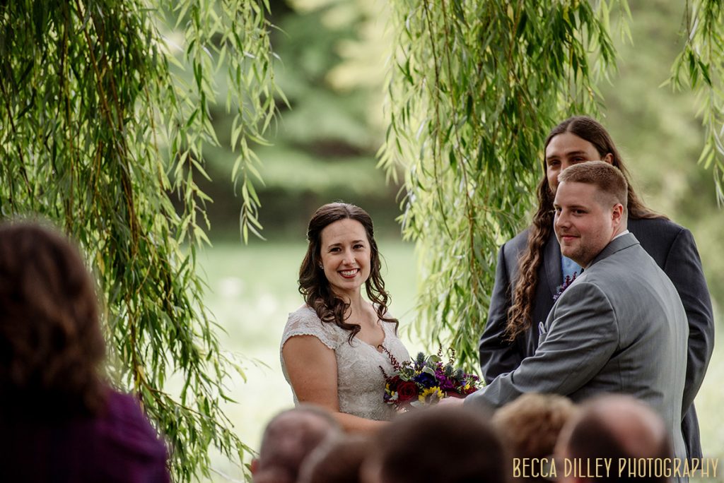 bride look over at guests during mn arboretum wedding