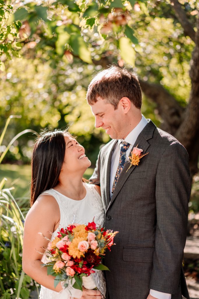 Couple look at each other in summer garden mn arboretum wedding