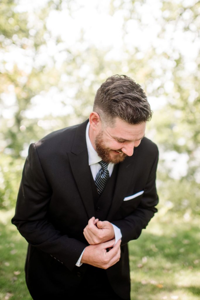 groom in minneapolis park before wedding sunny summer day
