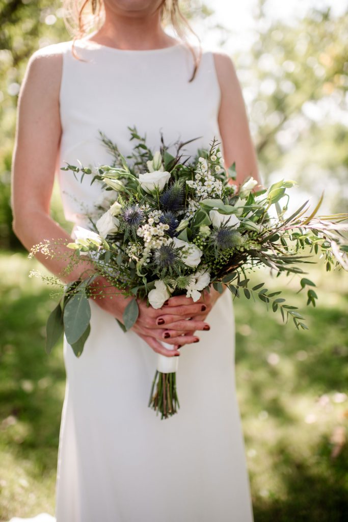 brides bouquet in minneapolis park before wedding sunny summer day