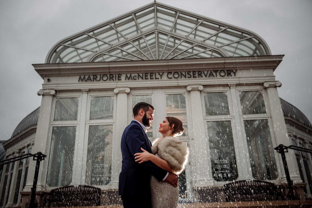 couple in rain outside of como conservatory wedding