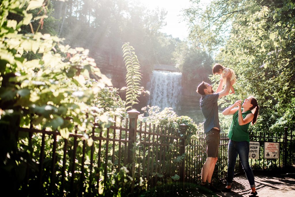 Minnehaha falls family portrait with father picking up toddler - Portrait Location Guide Twin Cities
