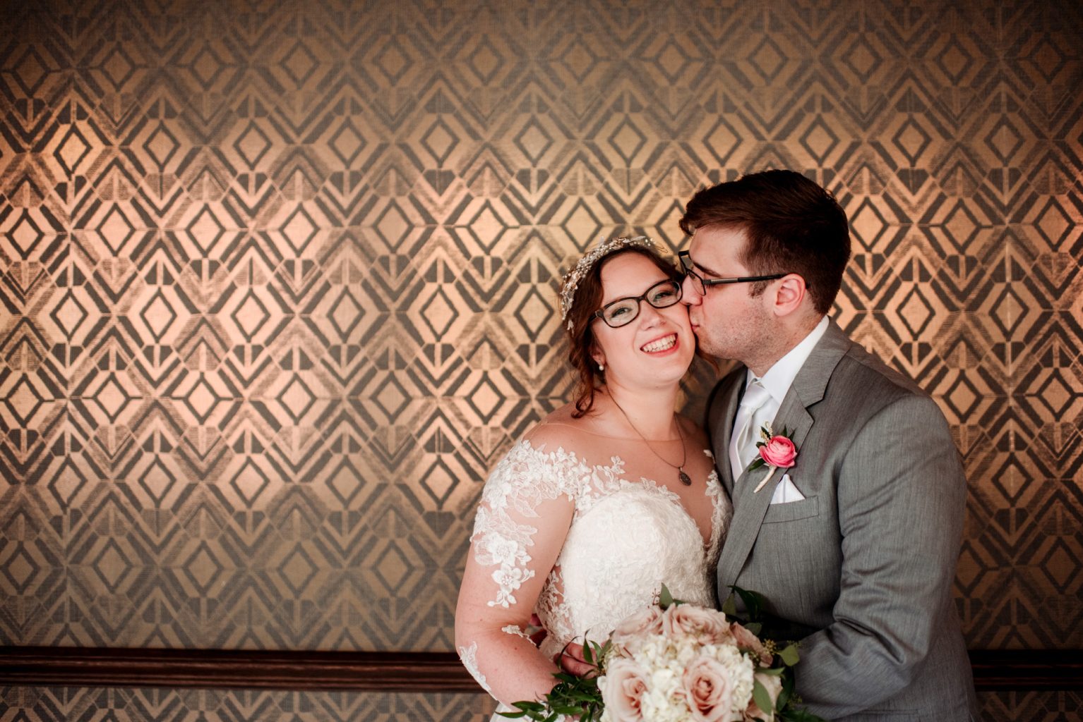 couple in front of golden wallpaper at Renaissance Minneapolis Depot wedding