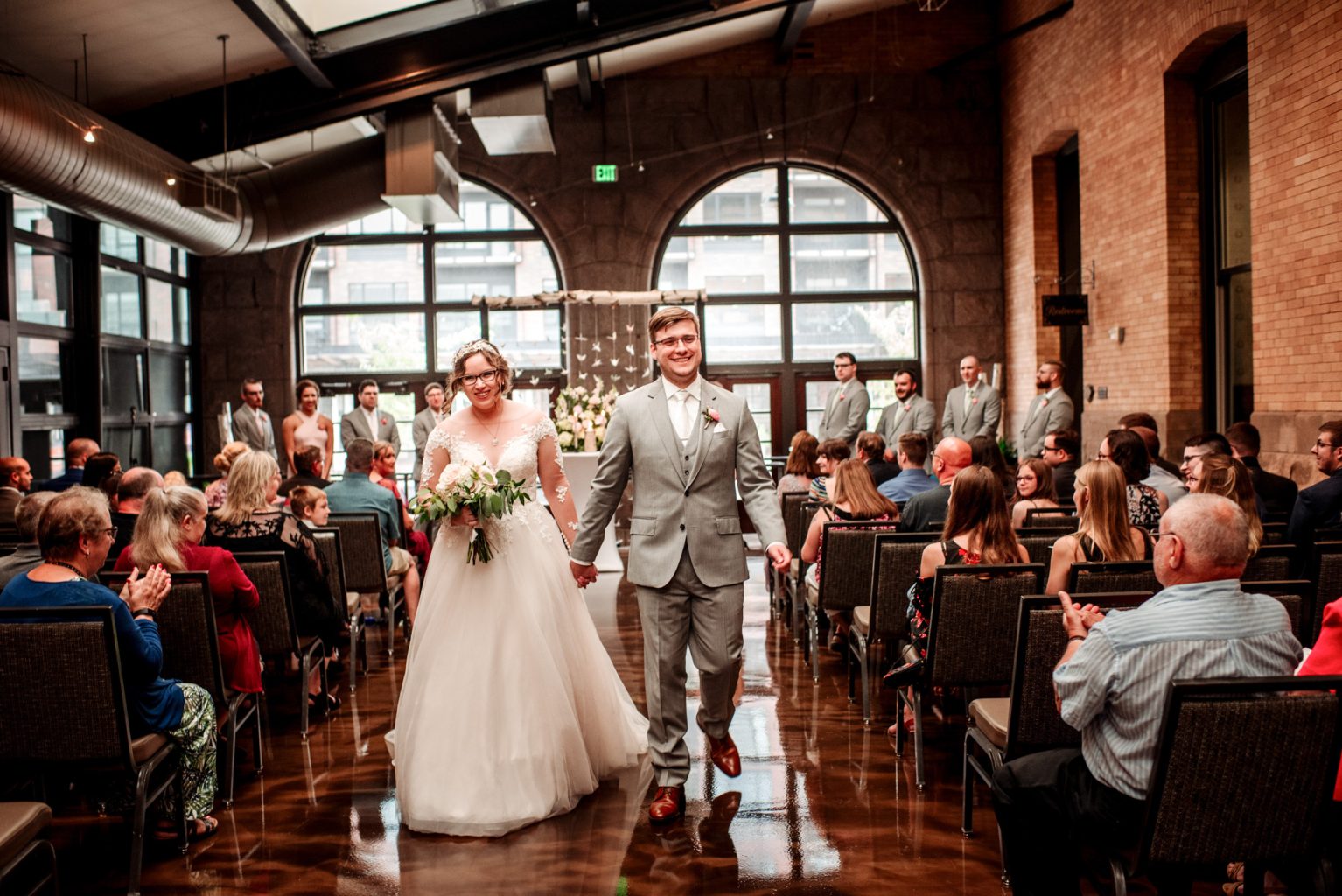 Couple walks down the aisle in their winter garden wedding Renaissance Minneapolis Depot wedding